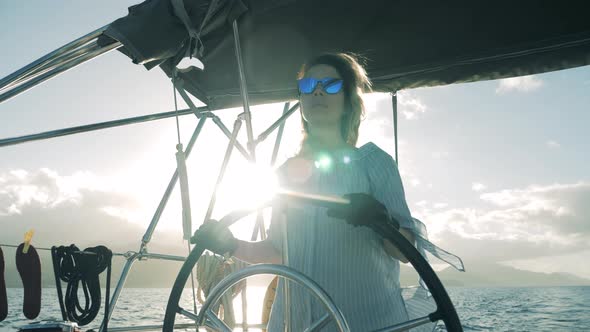 Woman in Glasses Sailing a Boat in Sea. Sea Travel, Summer Vacation of a Lady Skipper.