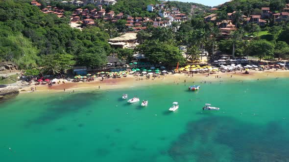 Arial shot over the colorful green waters of buzios bay in Brazil