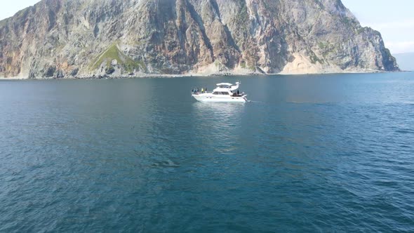 boat in the ocean near the rocks