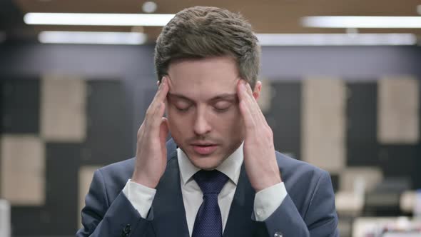Portrait of Businessman Having Headache