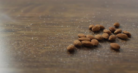 Video of almonds on wooden background