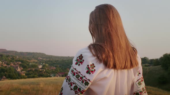 Happy Young Woman Enjoying the Sunset Wearing Traditional Ukrainian Clothes