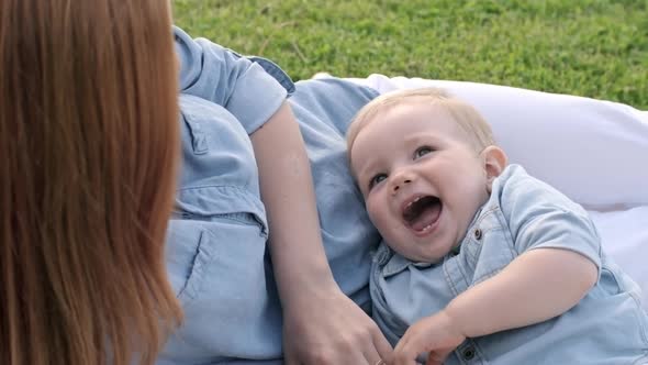 Mother Tickling Cute Baby