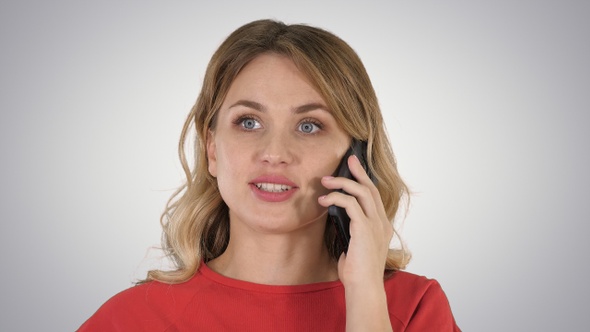 Happy Beautiful Girl Calling by Phone on Gradient Background.