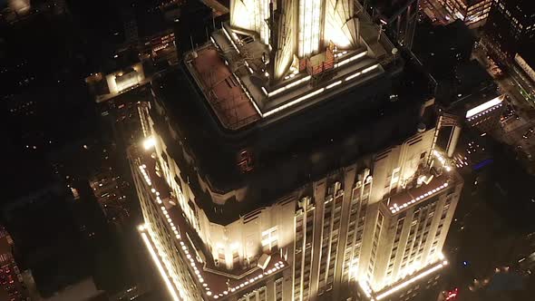 AERIAL: Breathtaking Circle Over the Iconic Empire State Building Above Lit Up Parallel Avenues and