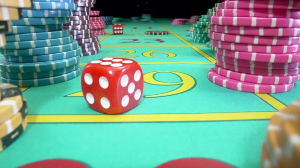 Camera Pans Over Green Gaming Table with Stacks of Casino Chips on a Black Background