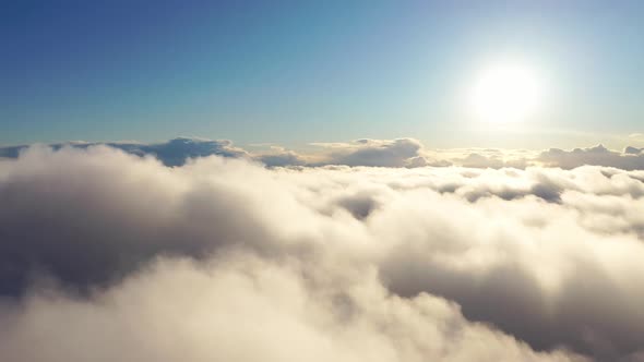 Aerial view up from the clouds to the sky in motion