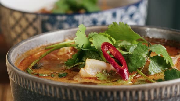 Tom Yam Kung Spicy Thai Asian Soup with Shrimp Rice Seafood Coconut Milk and Chili Pepper in Bowl