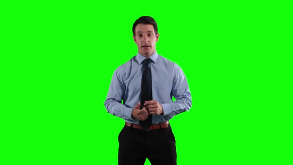 a Caucasian man in suit talking in a green background