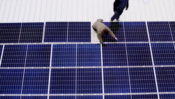 Solar Technician Installing Solar Panels on House Roof