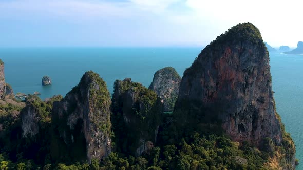 Aerial panning shot of large lime stone karst rocks at Railay Beach, Ao Nang, Krabi, Thailand