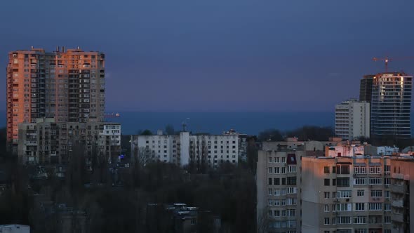 Sunset to Night Time Lapse Over Urban Skyline Near Waterfront