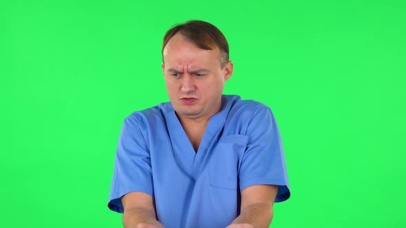 Medical Man Showing Disgust for Bad Smell or Taste. Green Screen