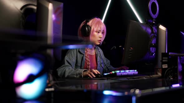 Professional Asian Video Gamer Taking Part in Cyber Sport Tournament Medium Closeup Indoors