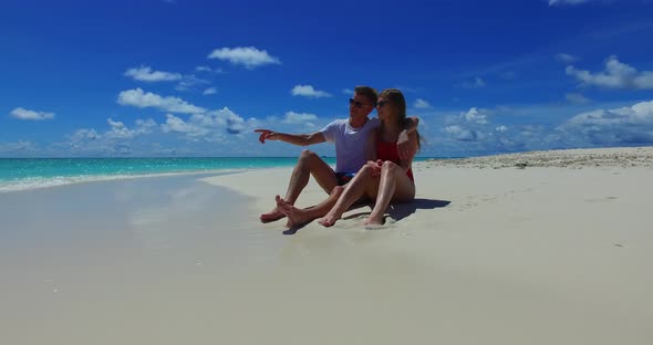 Romantic boy and girl on honeymoon vacation spend quality time on beach on paradise white sand 