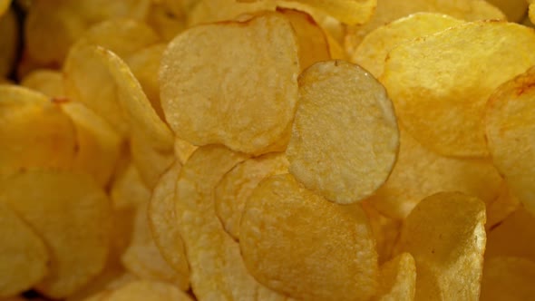 Super Slow Motion Shot of Potato Chips Flies After Being Exploded Against Black Background 1000Fps