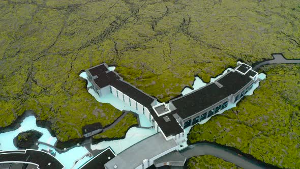 Top View Of The Resort Building Of Blue Lagoon Surrounded With Ice Blue Water And Vast Green Field.