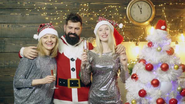 Christmas Group of Happy Young People. Bearded Hipster with Girls Friends Celebrate New Year Eve