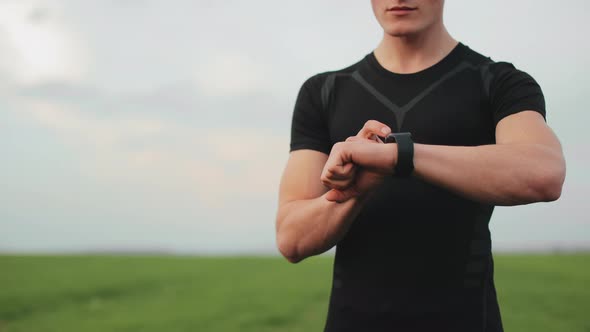 The Athlete is Start Training on His Watch and Start Running