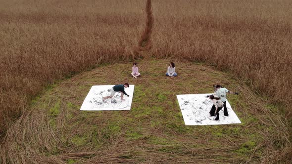 Shooting From a Drone of a Show with Dancing on Canvases for Painting in a Circle on a Wheat Field