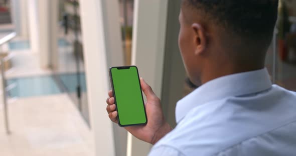 Guy Hands Using Phone with Mock Up Screen, Over Shoulder View of Afro American Man Touching and