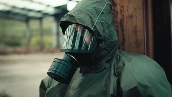 Soldier with Gas Mask is Resting on the Ground