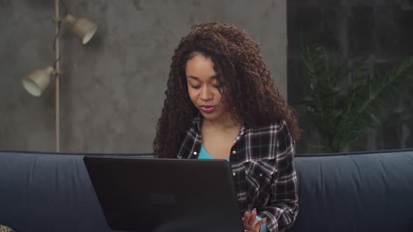 Portrait of Happy Woman Chatting Online on Laptop