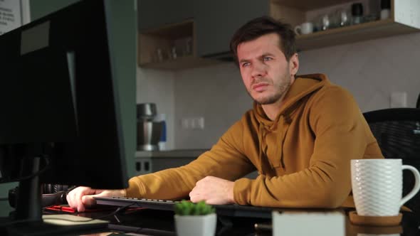 Freelancer Man Sleeps at Home Workplace with Computer