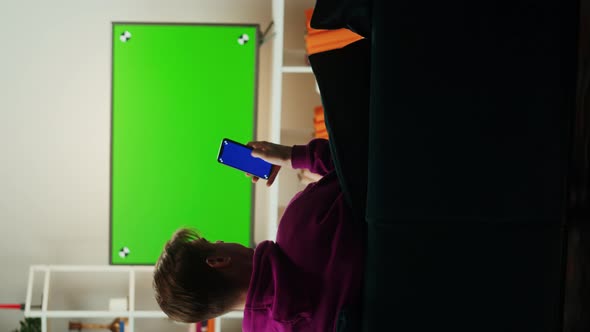 Vertical Video of Man Watching Television in Living Room