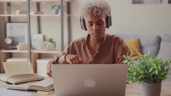 African Female Student Wear Wireless Headphone Study Online with Teacher