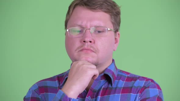 Face of Stressed Overweight Bearded Hipster Man Thinking and Looking Down