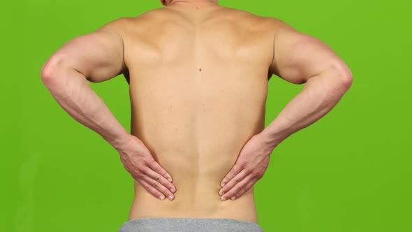 Man Suffering From Backache Painful Cramps, Severe Back Pain. Closeup