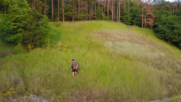 Traveler With Backpack. Aerial view of man with backpack hiking in nature