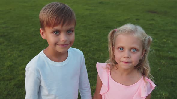 Cute Boy and Girl are Looking at the Camera