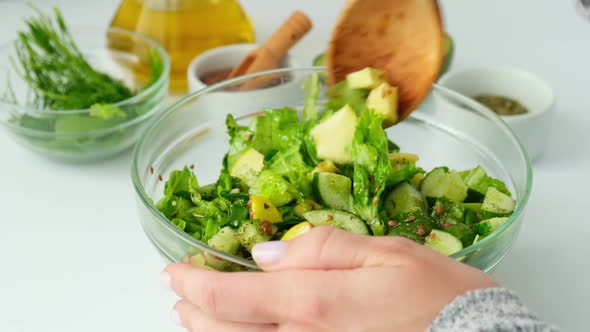 Woman Mix Salad of Fresh Green Vegetables and Herbs