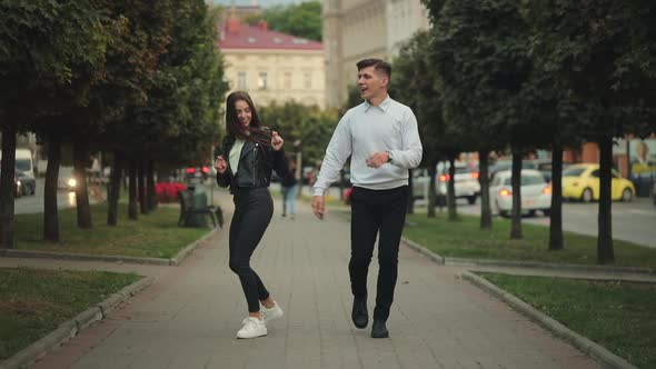 A Man and a Woman are Walking Around the City