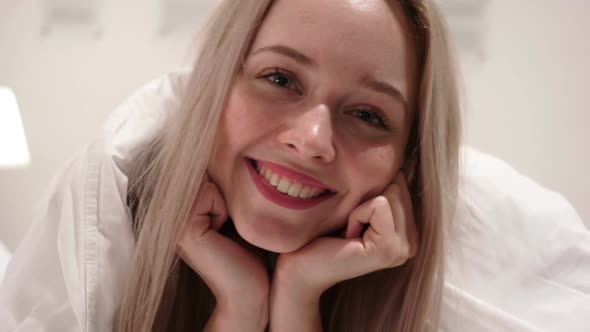 Close Up of Smiling Face of Woman Lying in Bed