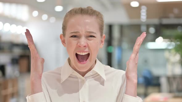 Portrait of Disappointed Young Businesswoman Screaming, Shouting 