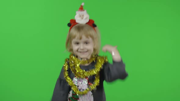 Happy Beautiful Little Girl in a Sweater with a Snowman. Christmas. Chroma Key