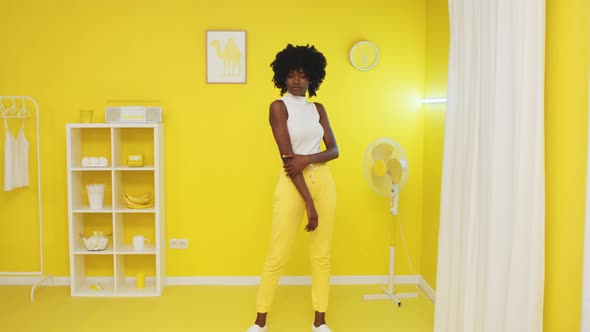 Portrait of Black Woman In Illuminating Yellow Room