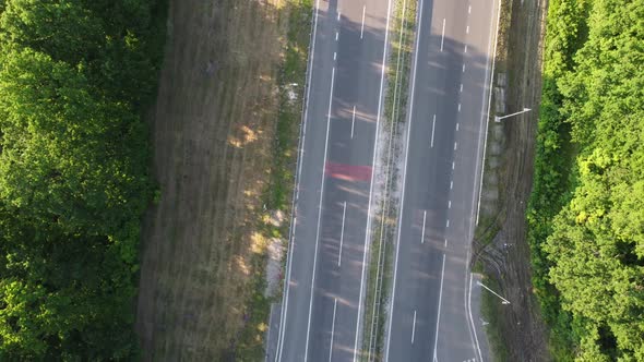 Aerial View on Highway Road Through Green Fields on a Summer Sunny Day