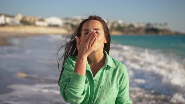 Slim Happy Young Caucasian Brunette Woman Sending Air Kiss Showing Heart Shape Looking at Camera