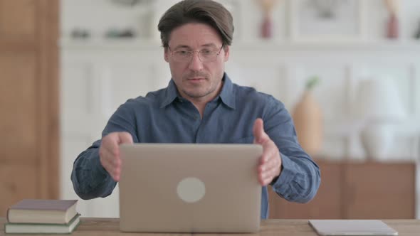 Man Closing Laptop Standing Up, Going Away