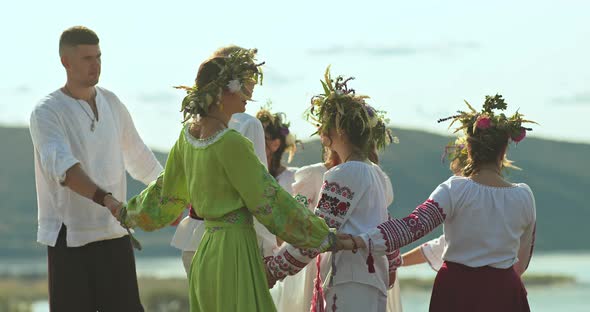 Slavic People Lead a Round Dance in Folk Costumes