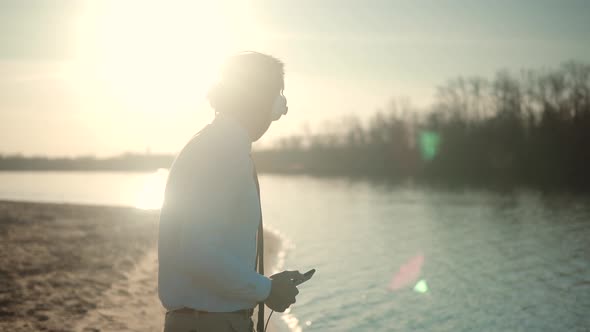 Man Listening To Music In Headphone. Businessman Joyful Walking And Listening Music On Headphone.