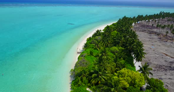 Luxury above copy space shot of a white paradise beach and blue water background in vibrant 4K