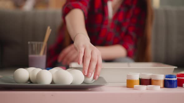 Young Woman Takes Egg to Paint Using Ebru Art Technique