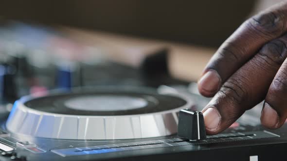 Closeup Unrecognizable DJ Man African American Male Finger Using Mixer Controller Desk in Club