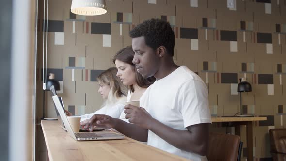 Focused African American Professional Sitting at Counter