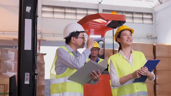 asian Male and Female Industrial Engineers in Hard Hats